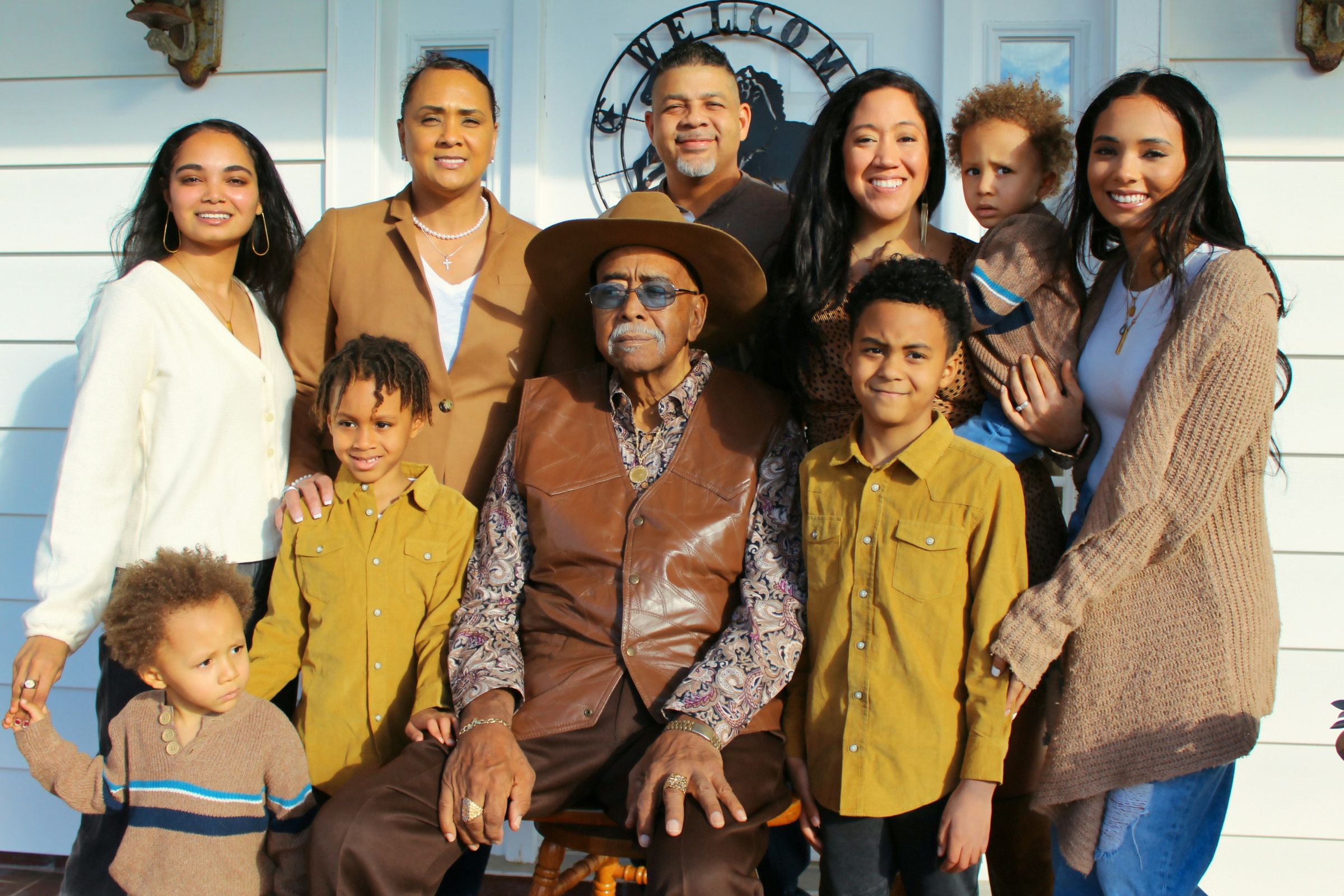 A smiling multigenerational family on a front porch
