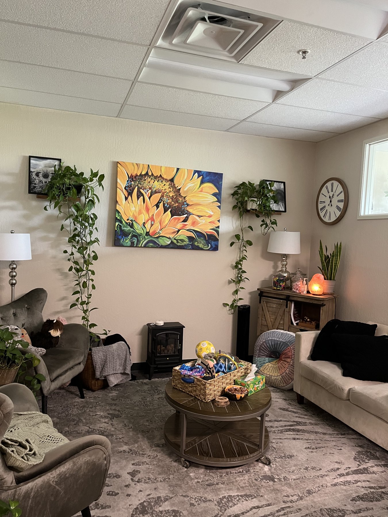 Our Brentwood therapy room with sunflower artwork and plants