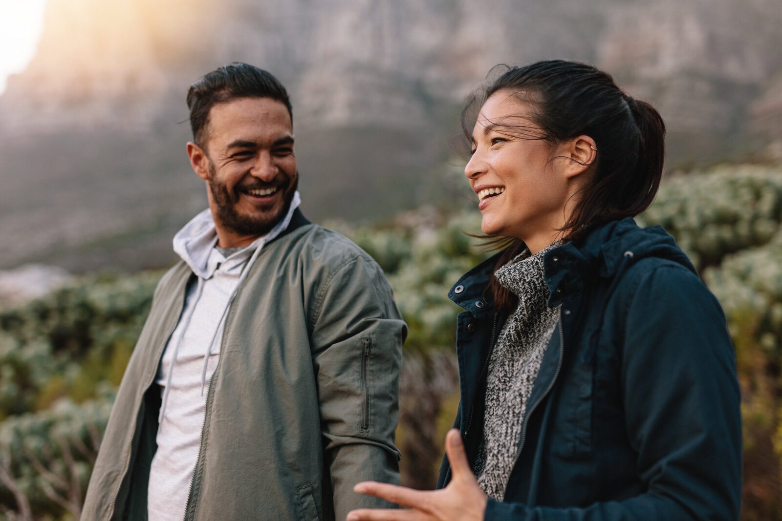 Two adults laughing together outdoors